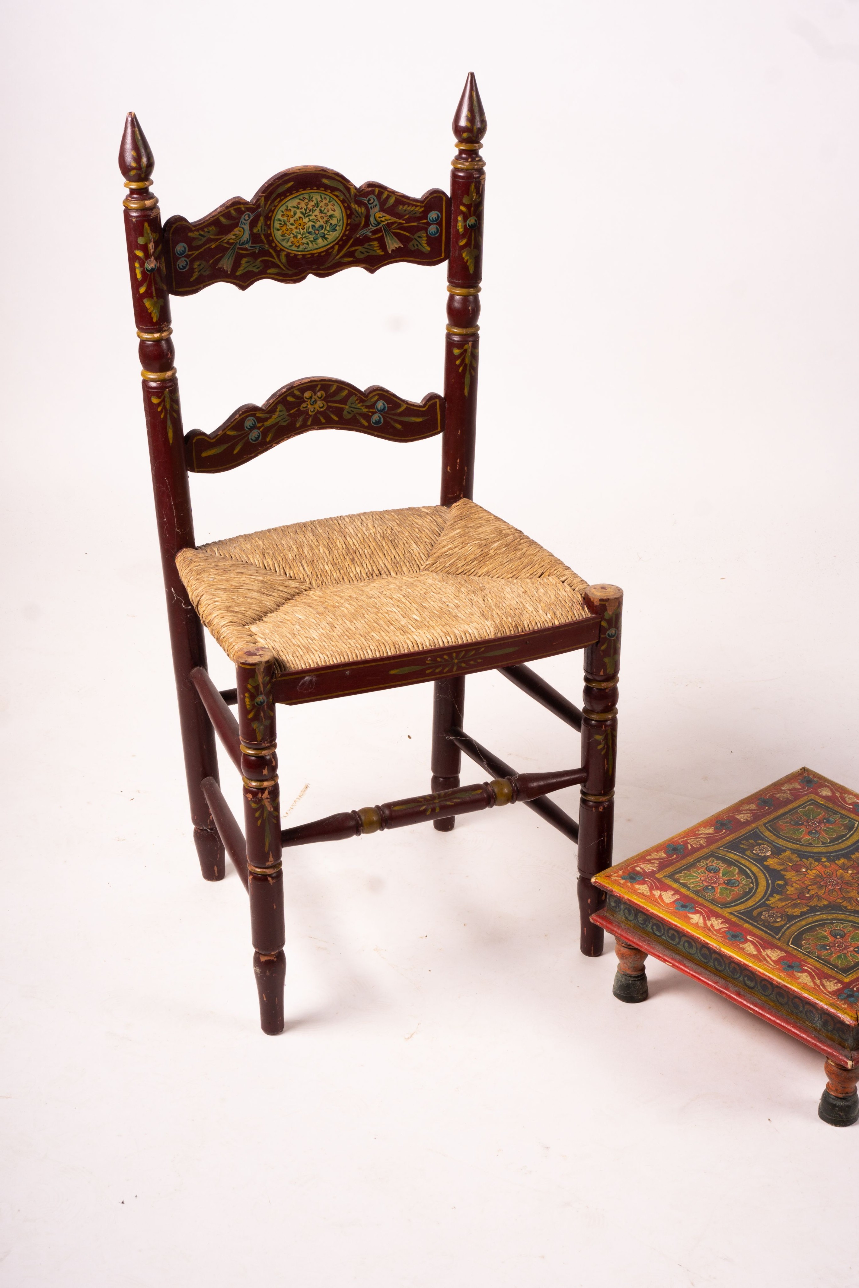 Two 19th / early 20th century Swiss painted rush seat chairs, together with a square low table